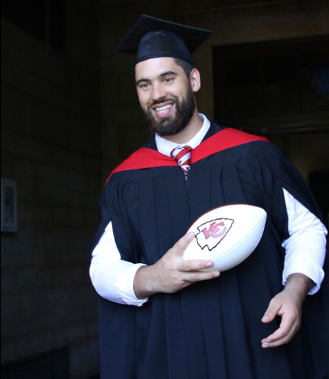 Photo of Laurent Duvernay-Tardif holding a football