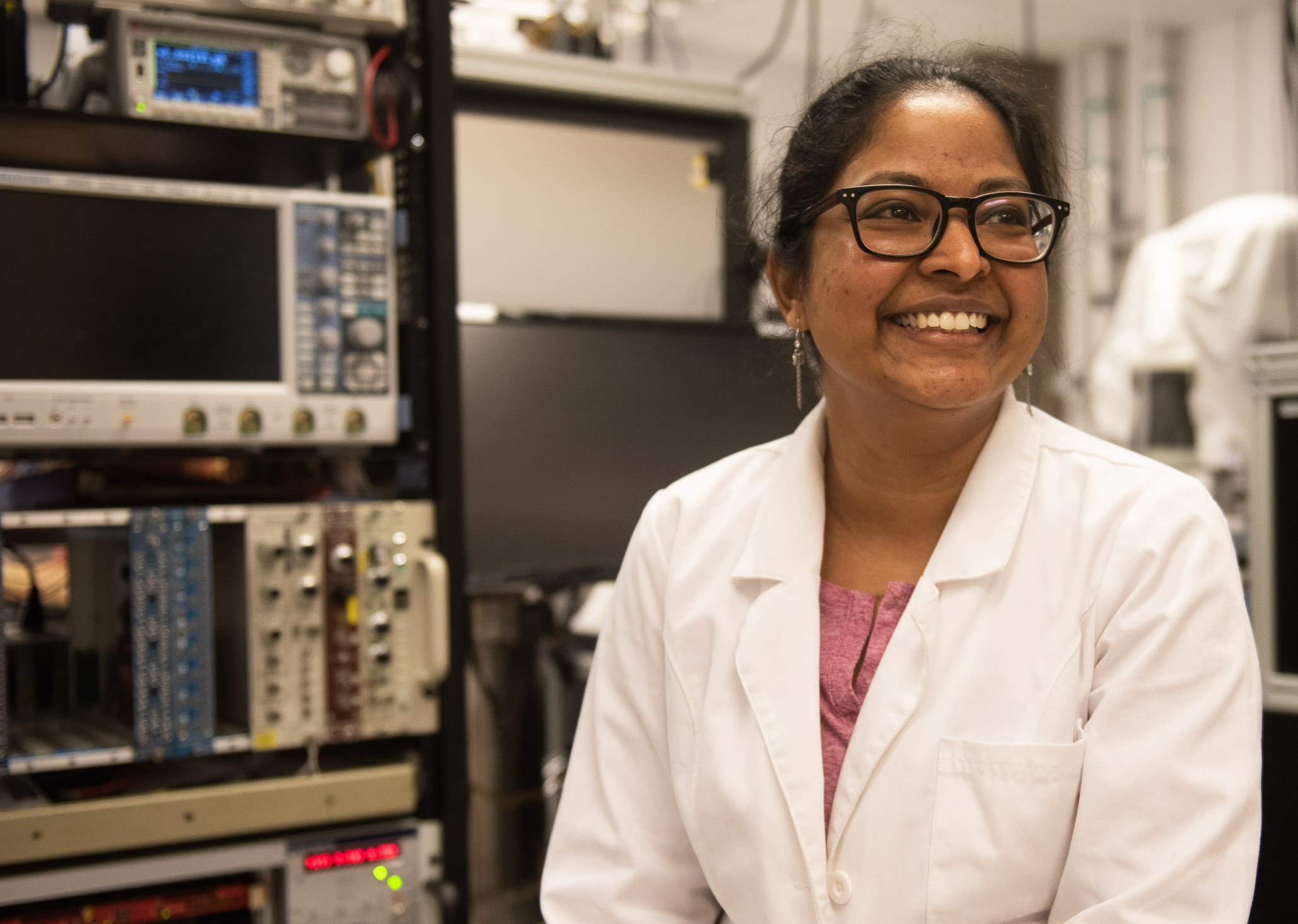 Bernadette Rebeiro smiling at something behind the camera in the Brunner lab.