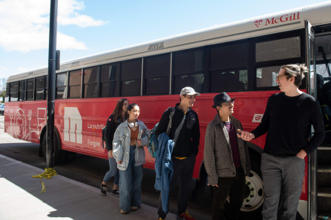 Students in line to board the inter-campus shuttle bus at Macdonald Campus