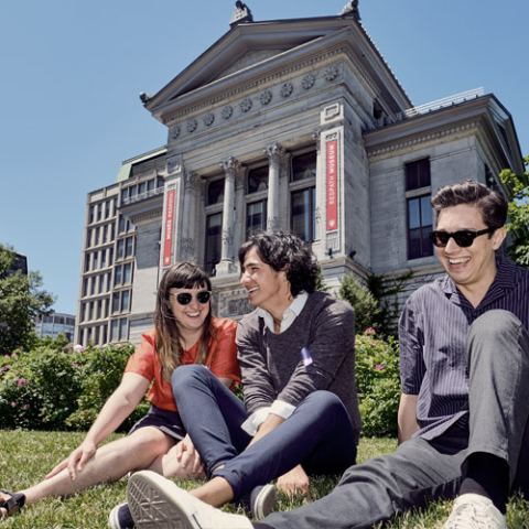 Students sitting outside on a hill at ƻԺ's downtown campus.